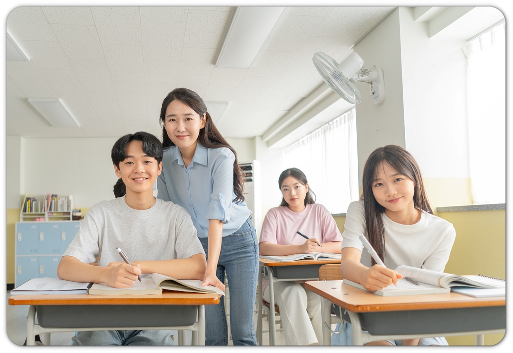교실에서 학생의 과제를 살피는 모습 · 학년·학교생활 참고 사진